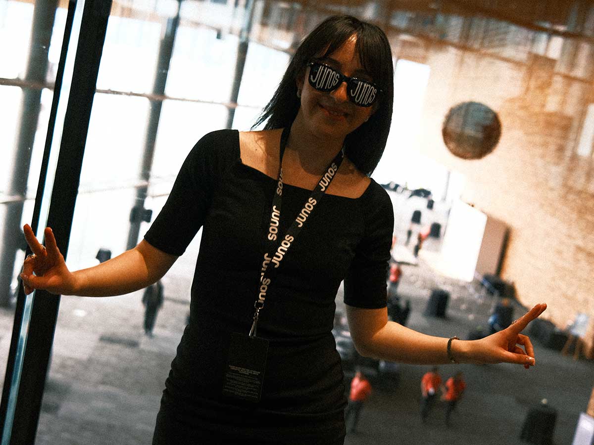 Woman wearing black sunglasses with the word ‘Junos’ painted on them at the Juno Awards Gala 