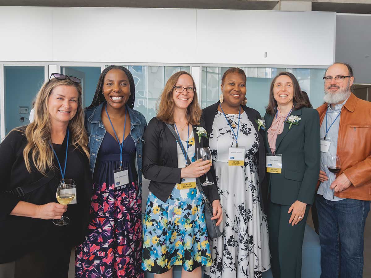 Current and past recipients pose alongside TMU staff and guests
