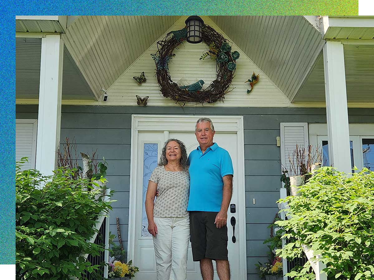 A couple stands on the front steps of their bed and breakfast. Credit: Doug Speare