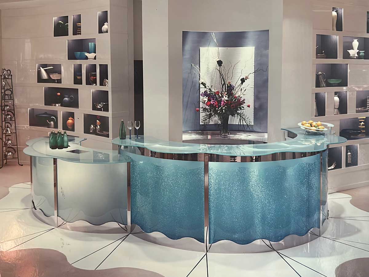 A reception area with blue toned glass and decor and artwork on the walls.