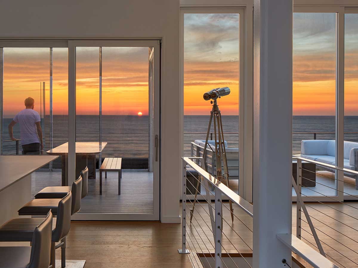 A modern home illuminated at dusk