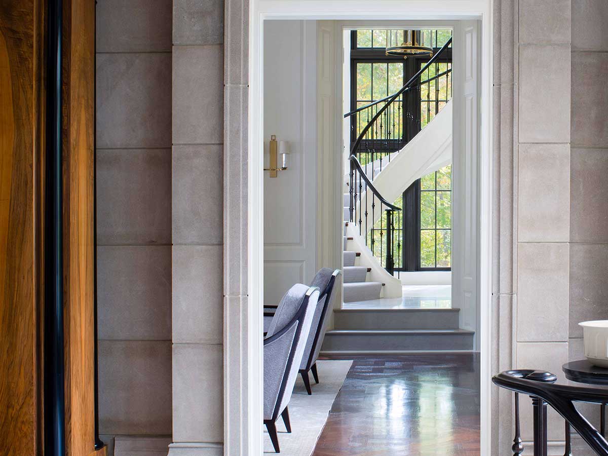 A look inside a traditional home, through a doorway leading to a set of stairs.