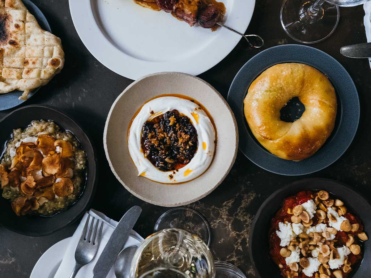 Multiple Greek-inspired dishes arranged on a table