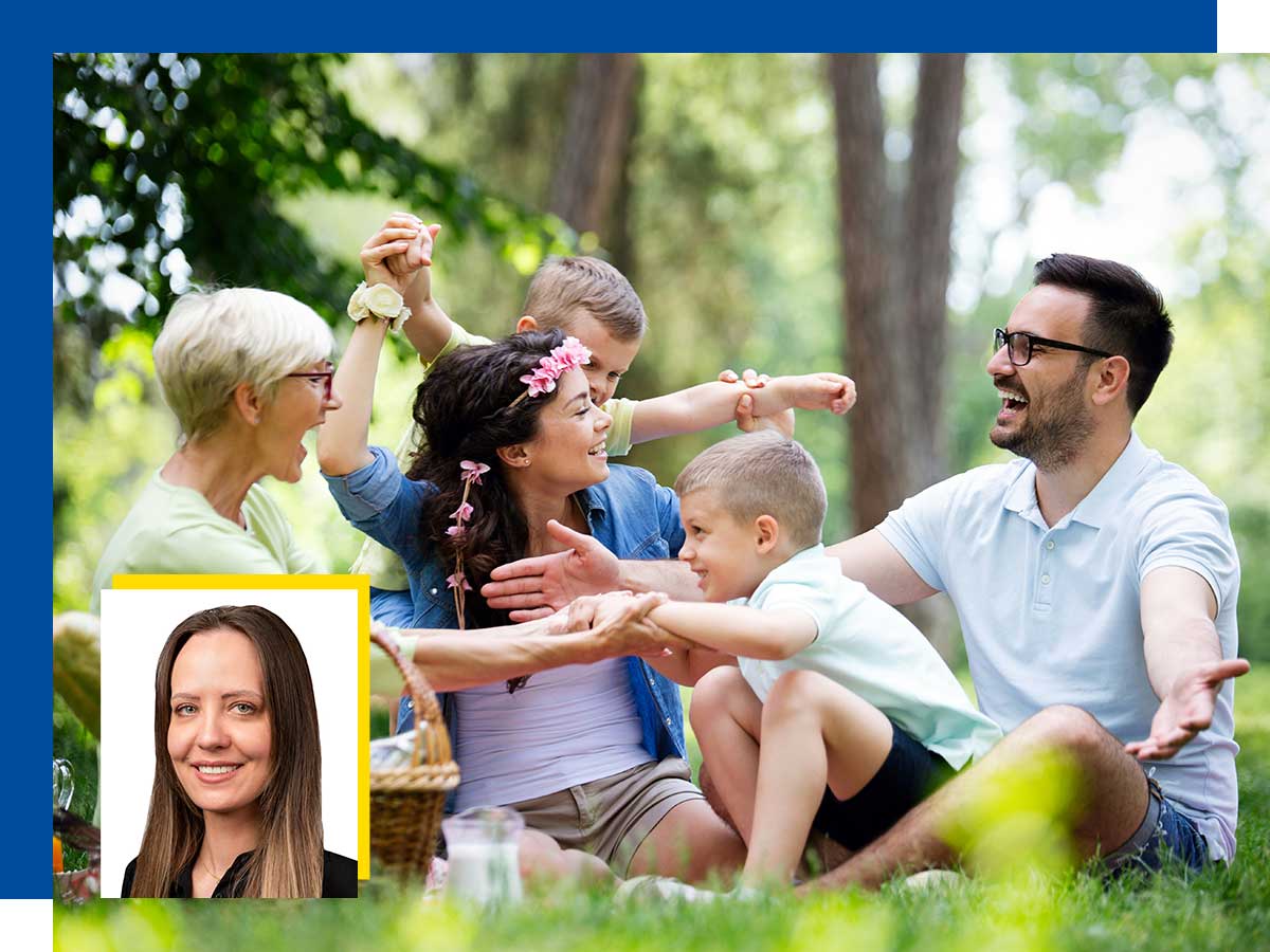 A family sits on the grass in the forest