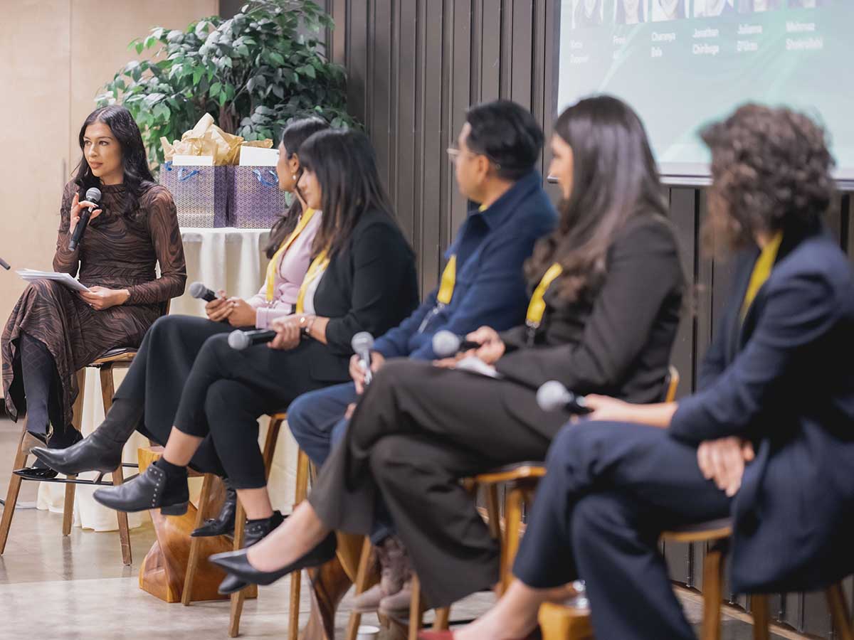 The panel moderator addressing the audience.