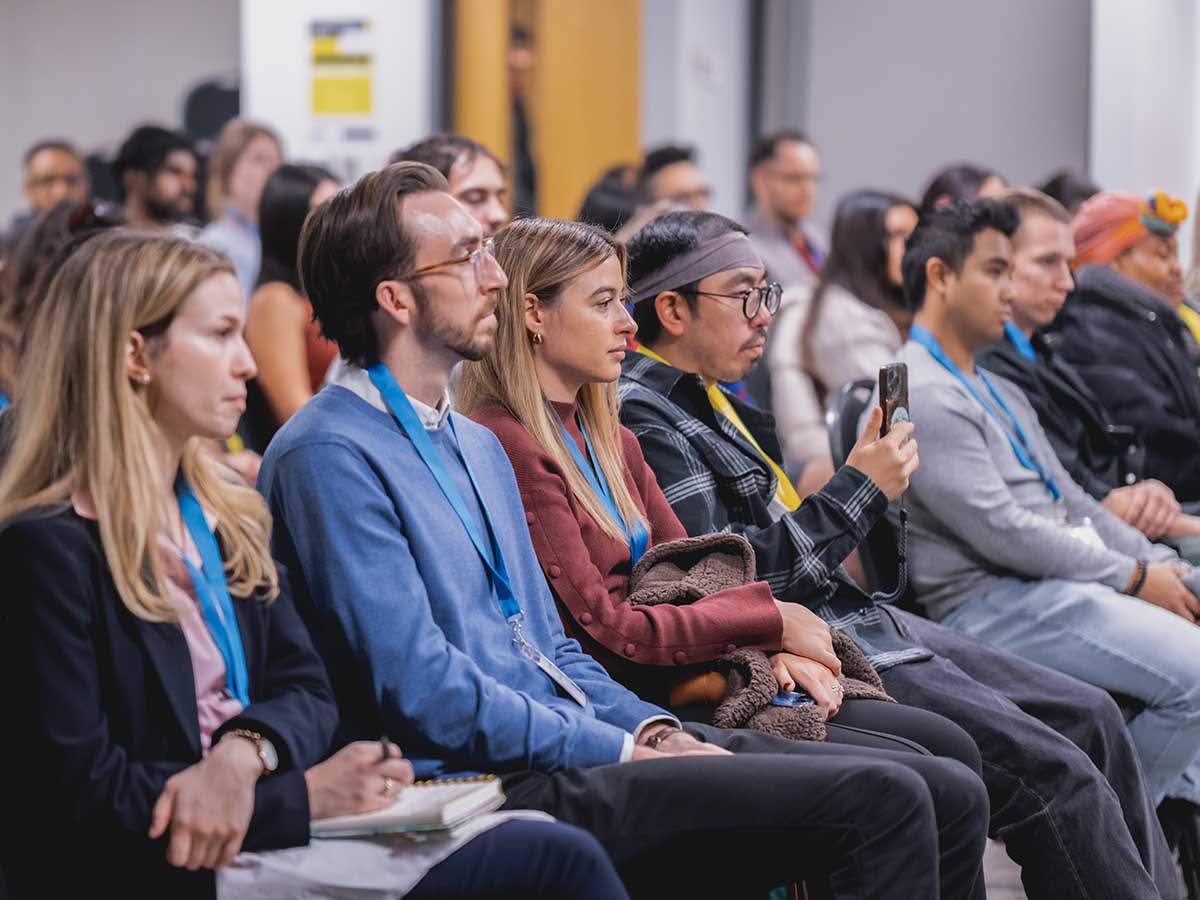 The audience sitting down and listening intently.