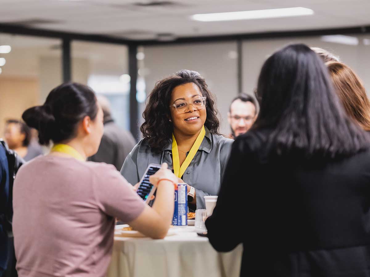 Guests attending the panel event networking. 