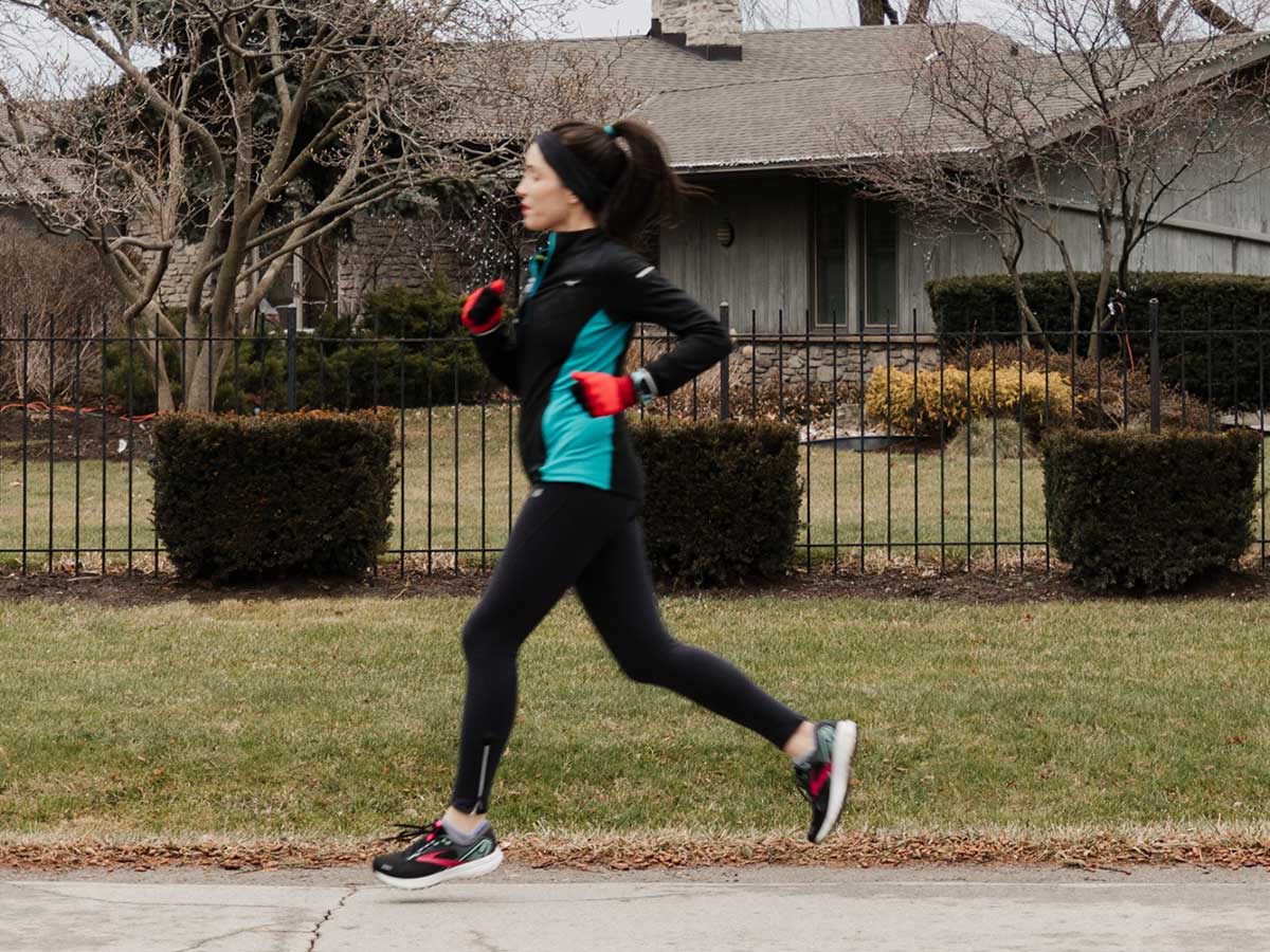 Woman runs on a suburban neighbourhood street. Photo by Amanda Sarah Cherish