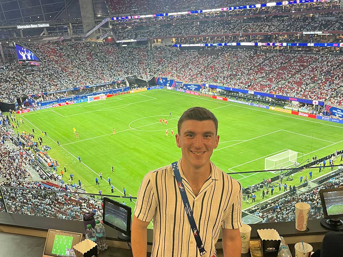 Benjamin Steiner on assignment in stadium stands overlooking soccer pitch