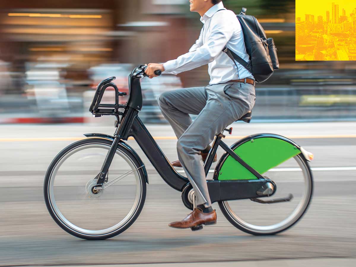 The Forefront — a commuter pedaling a bike share bicycle.