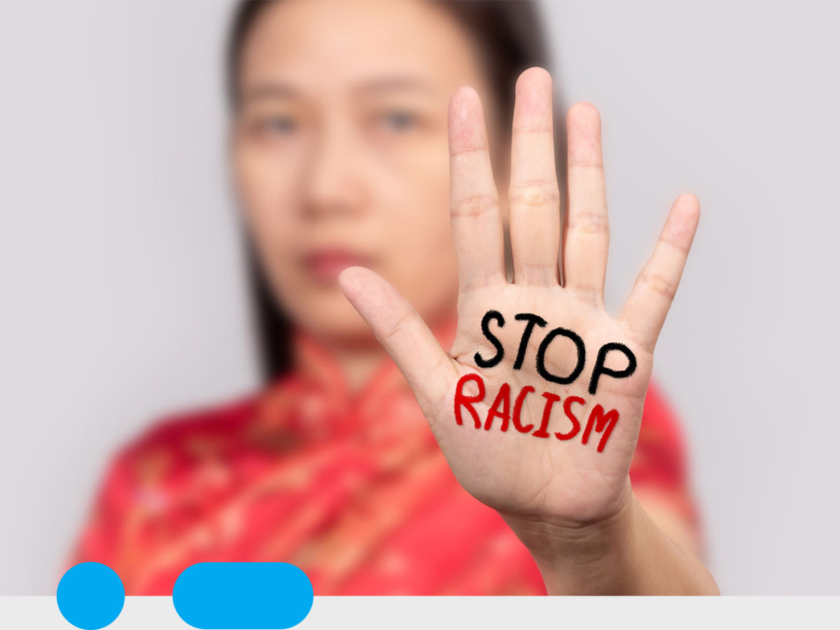 Person with "Stop Racism" written on their hand