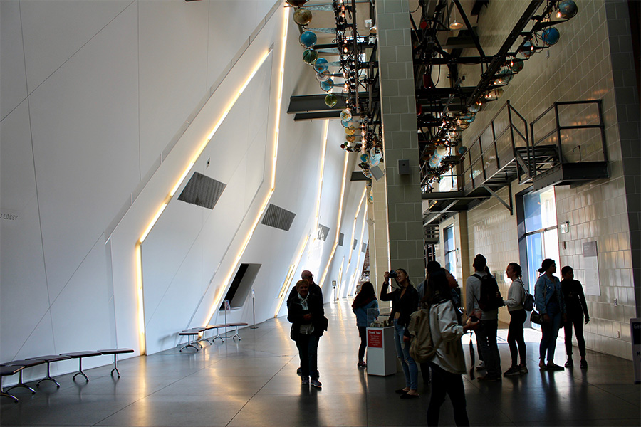 Students examining the inner details of architecture in a building