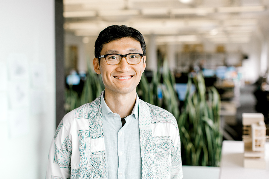 Andrew Chiu smiles in an bright office 