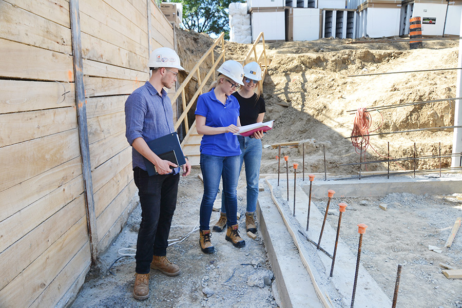 Building science students surveying a construction site