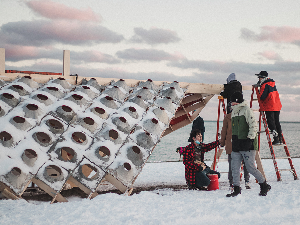 Students assemble their pavilion S'Winter on the beach, as part of the Winter Stations design competition. 
