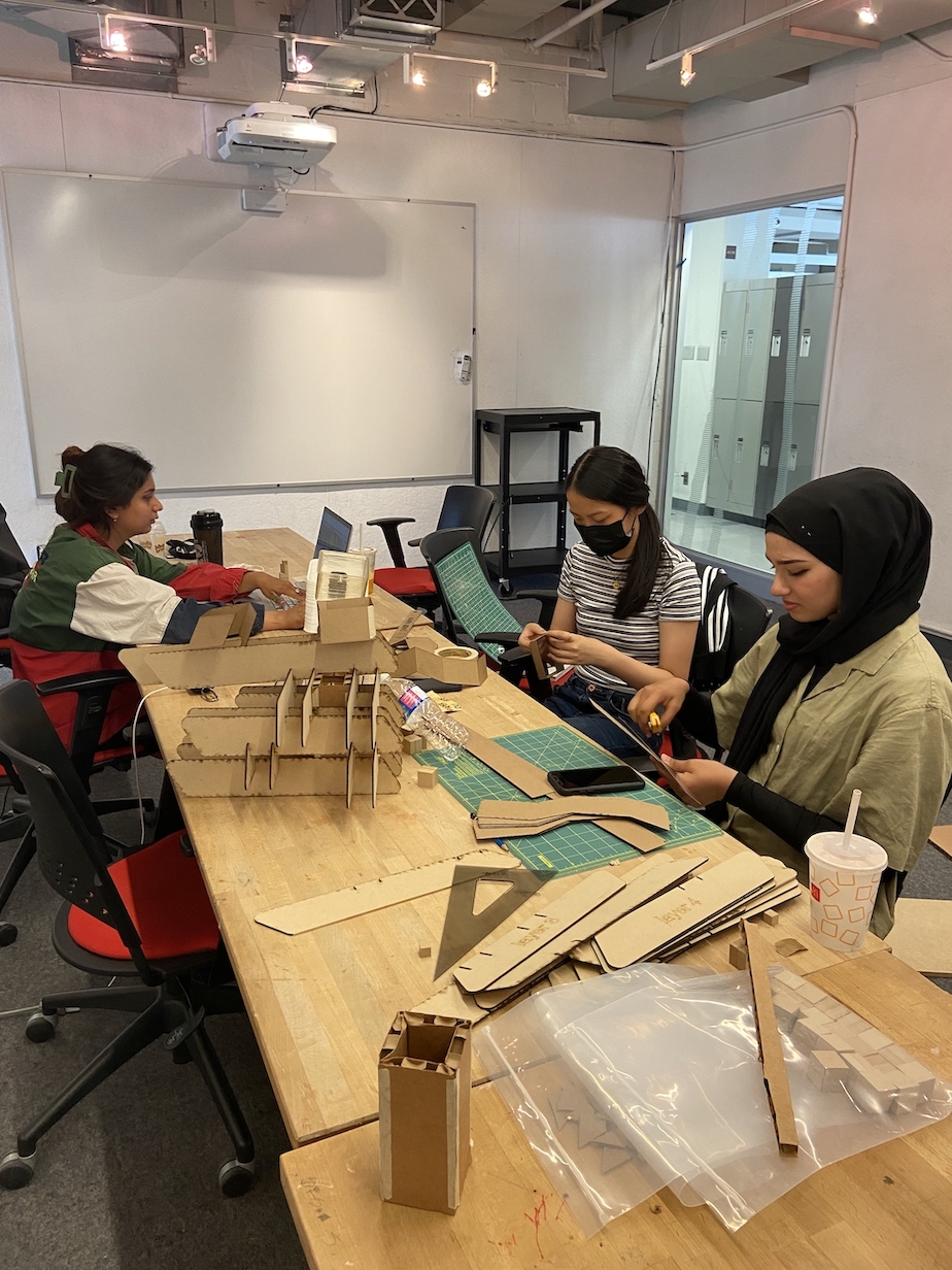 Students assembling the laser-cut pieces of the Cloud model. 