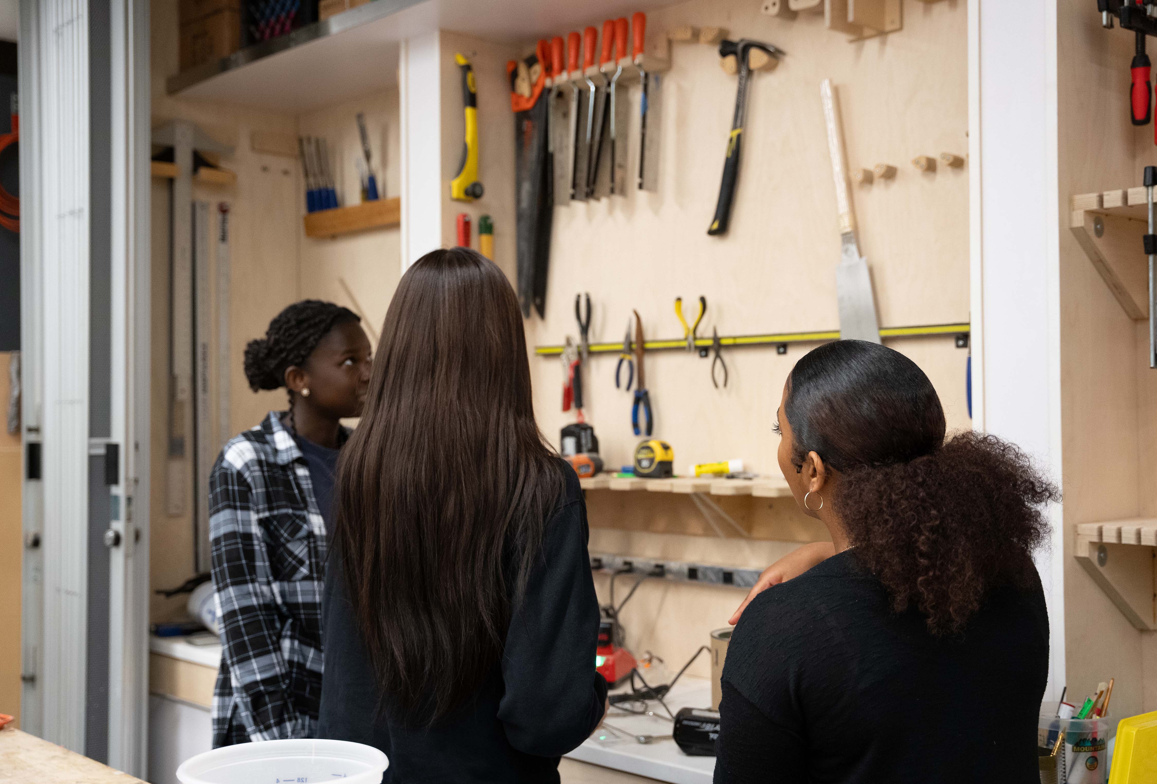 Students at the workshop looking at tools