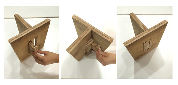 A triptych shows the assembly of a wooden cross-shaped stand. The left panel shows a person inserting a wooden piece into a slot, the middle panel shows the same piece being pushed further in, and the right panel shows the completed stand from a different angle.
