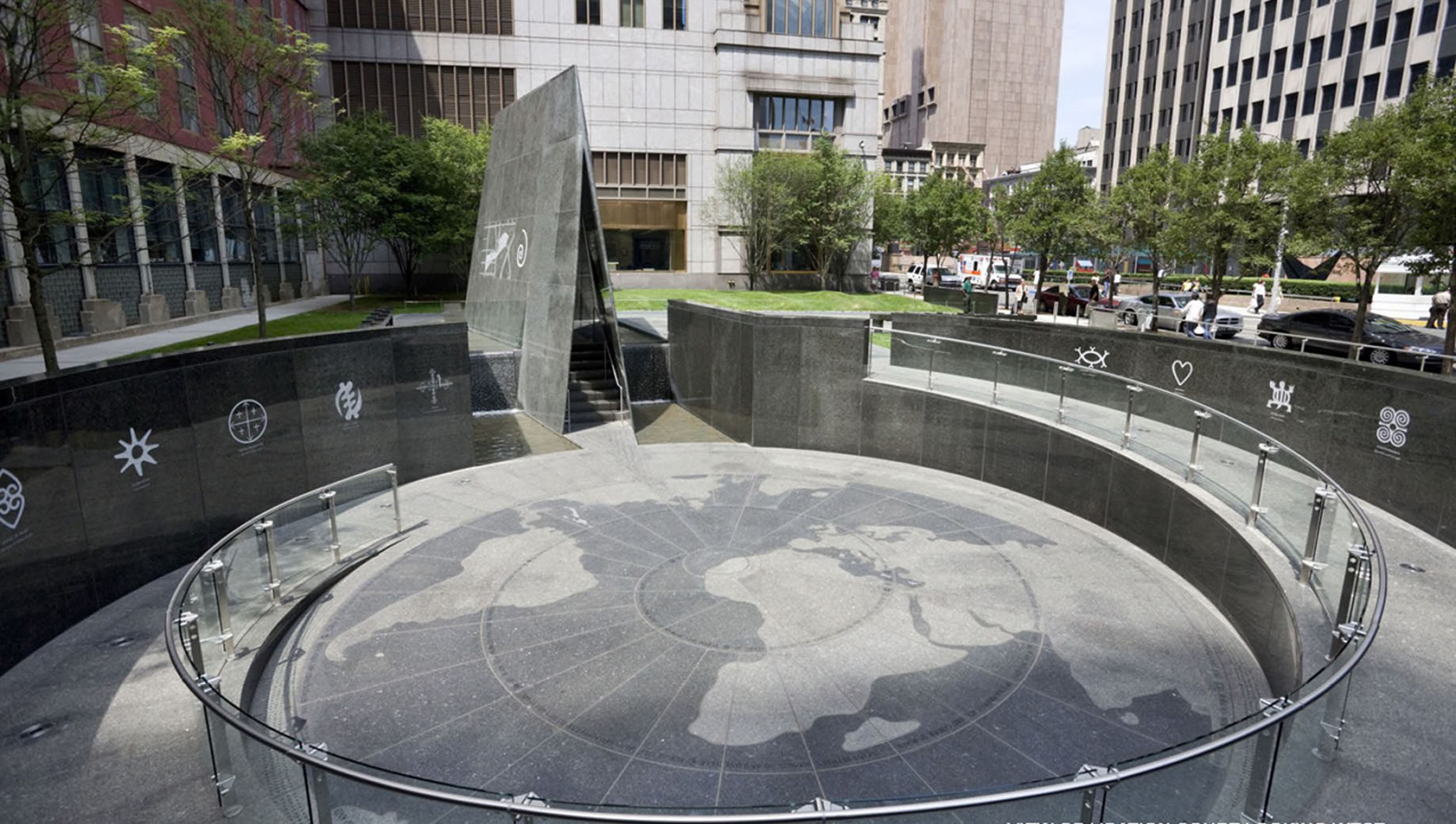 A globe-like motif on pavement in a public space