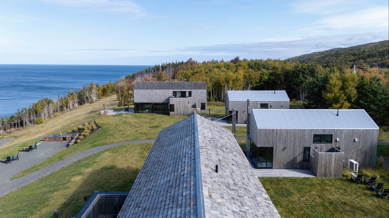 Overhead shot of a building's exterior with the view of the ocean 