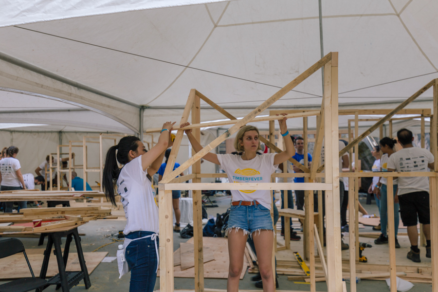 Two students construct a building during Timber Fever