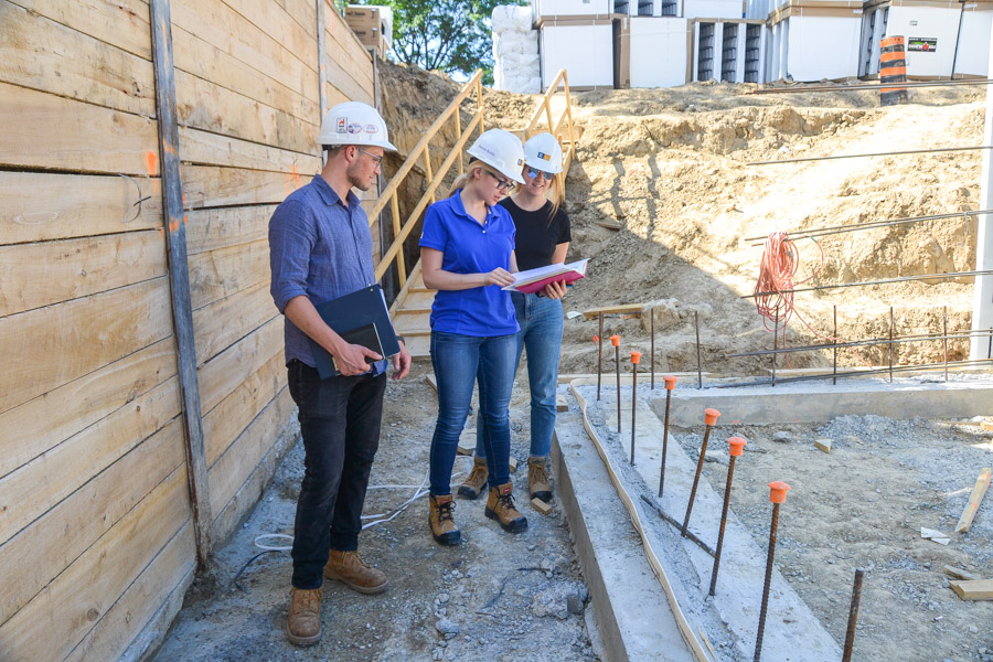 Building science students surveying a construction site