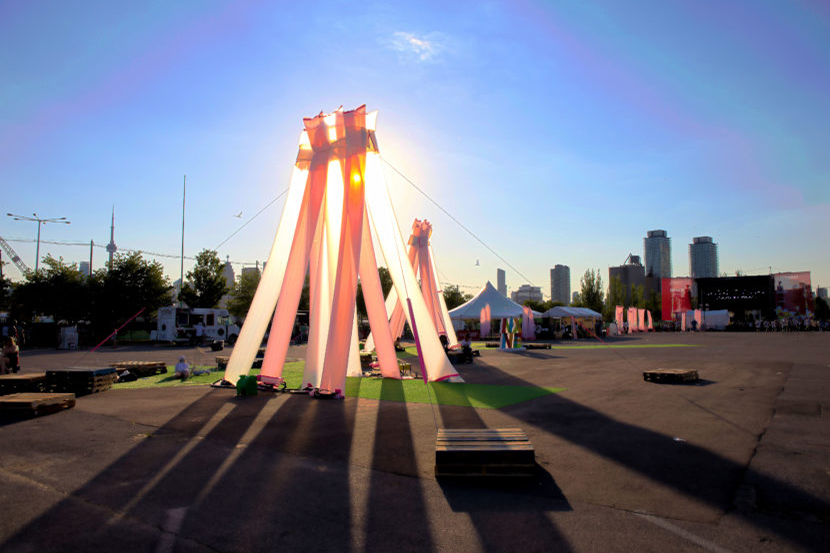 An art structure with the sun setting behind it