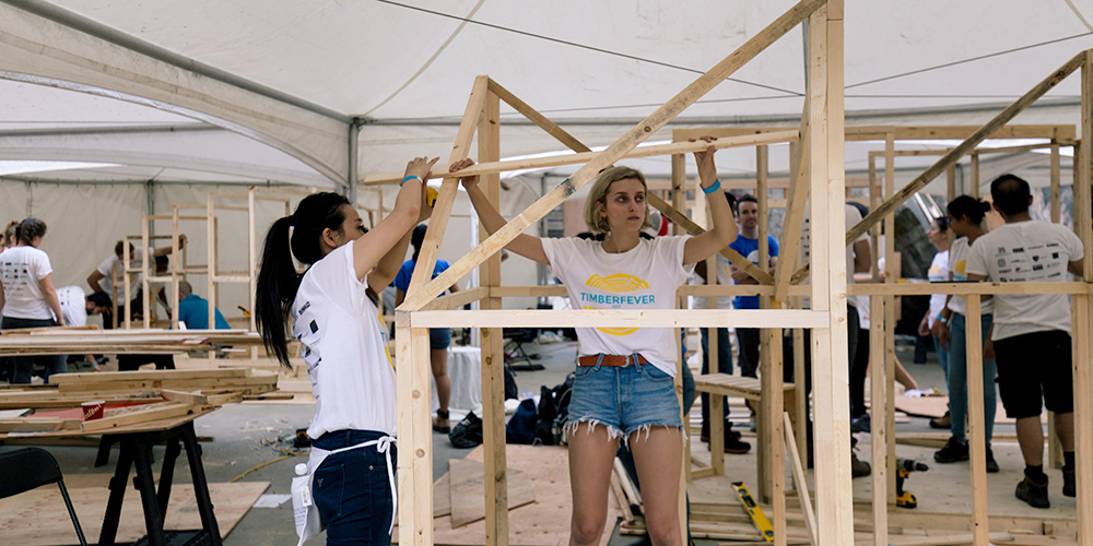Two students erecting a structure for Timber Fever