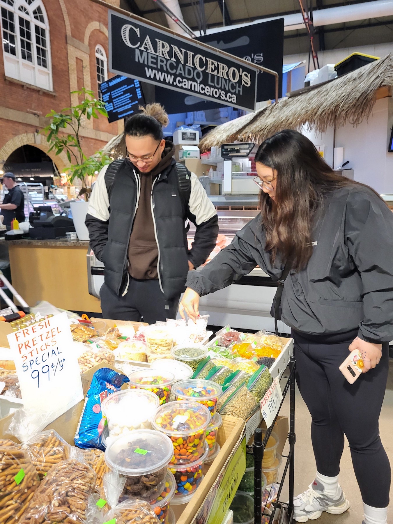 A pair of students browse for bulk goods