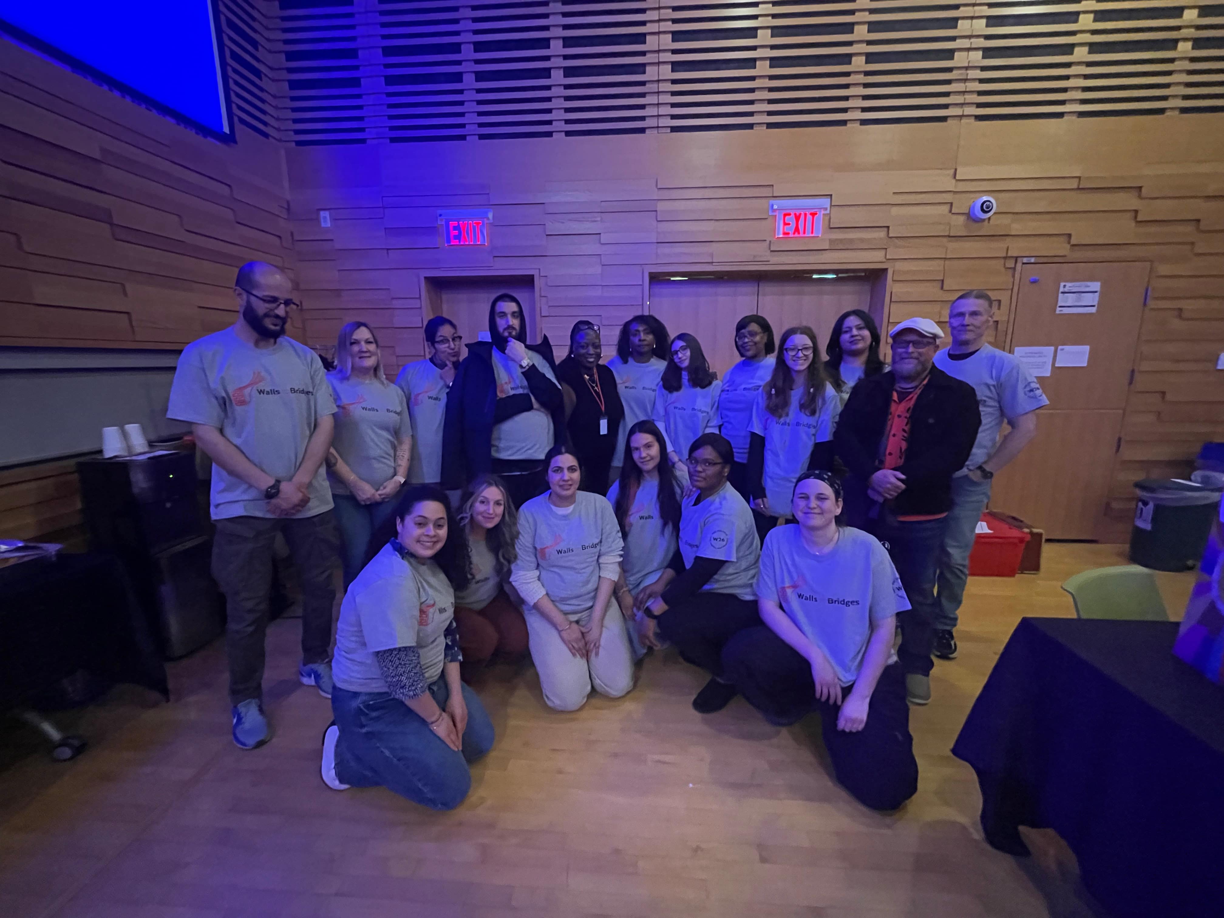 Class of the W2B Winter 2026 Cohort all together in a group photo. All of them are wearing a W2B shirt that is grey with the logo in an orange and text in black. They are all smiling and happy to be there. 