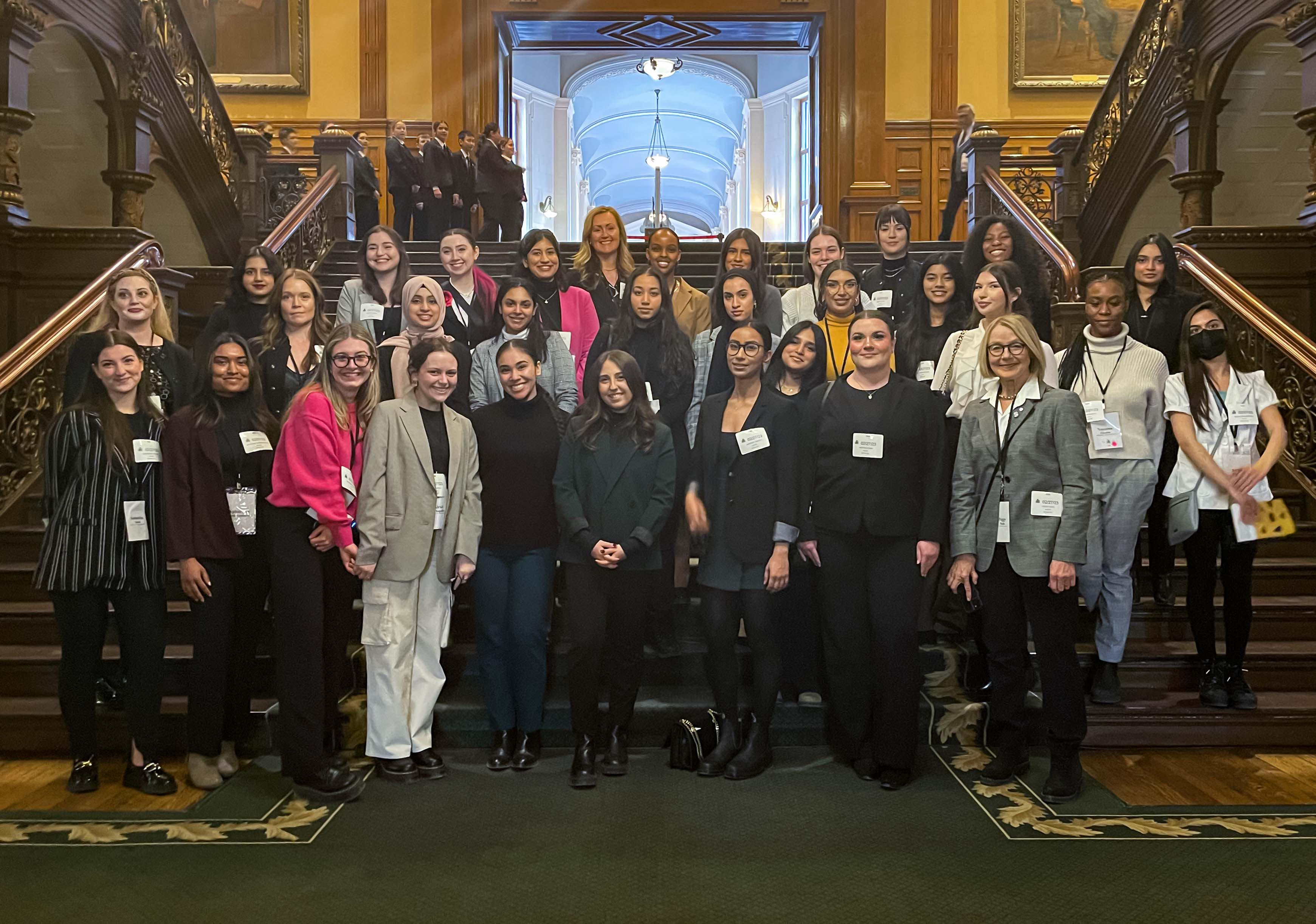 Women in the House Cohort at Queen’s Park standing on the grand staircase
