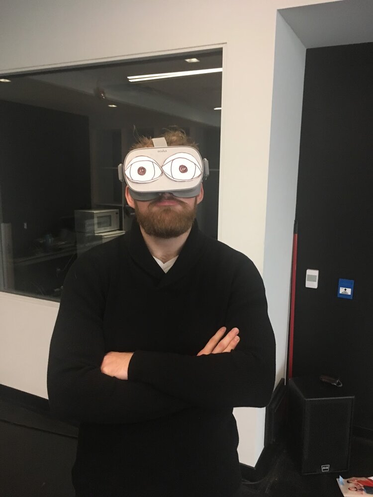 Research participant wearing a VR headset, with hand-drawn cartoon eyes on the headset.