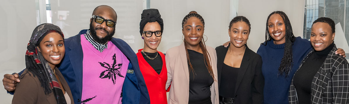 Black TMU community members pose for a group photo together at an event. 