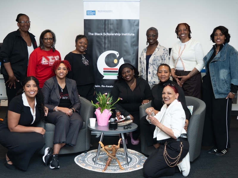 Group of Black authors gathered around a banner for The Black Scholarship Institute