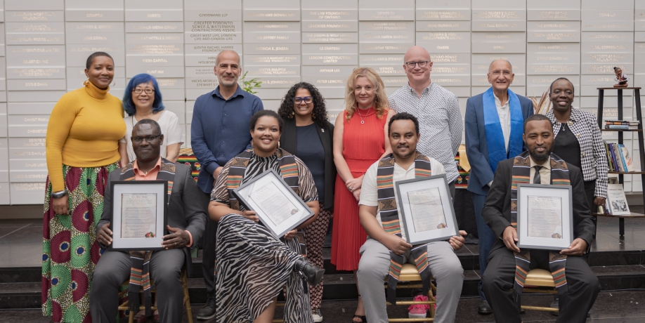 Group of postdoctoral fellows pose with certificates and senior leadership