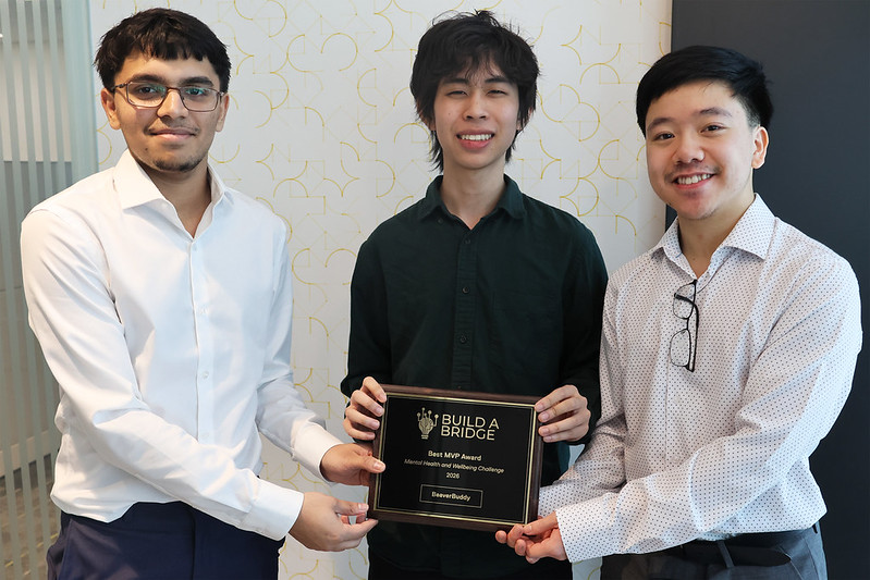 BeaverBuddy's  Aryan Desai, Gaston Chung, and Matthew Phang pose with their award plaque.