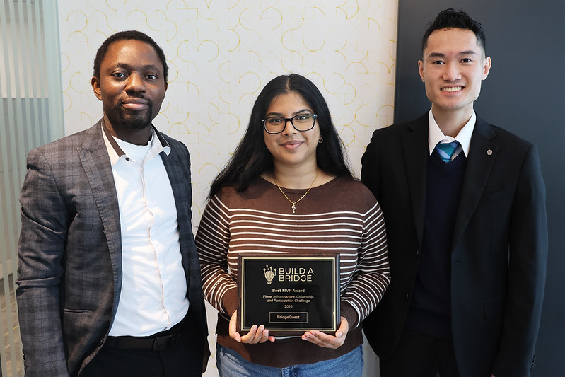 BridgeQuest's Sean Nguyen, Shreya Dasoju, and Augustine Farinola pose with their award plaque.