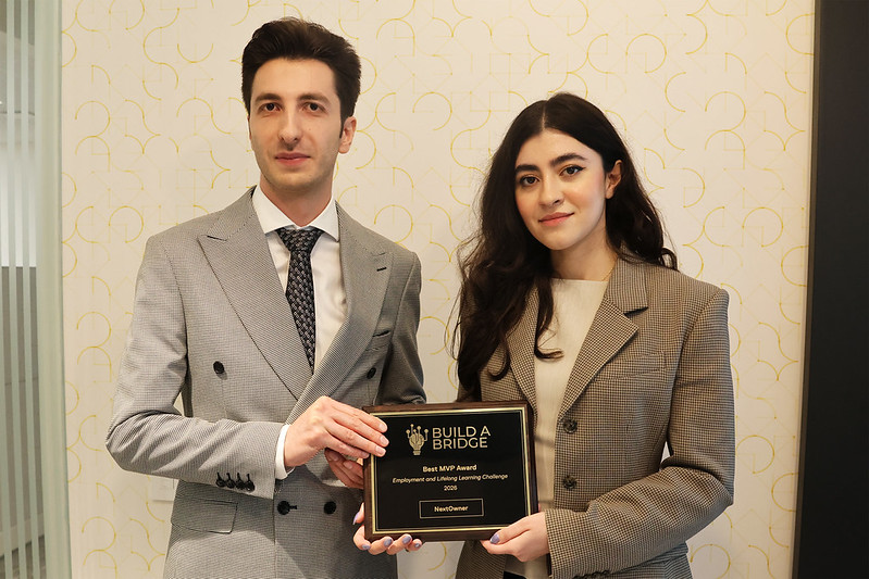 NextOwner's Bita Deravian and Hojat Asgariandehkordi pose with their award plaque.