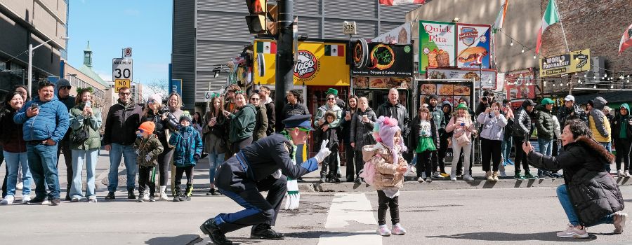 An official was seen posing with a child while the child's mother took a picture of them, as a large crowd watched this endearing moment