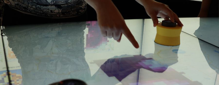 Someone pointing at a digital map