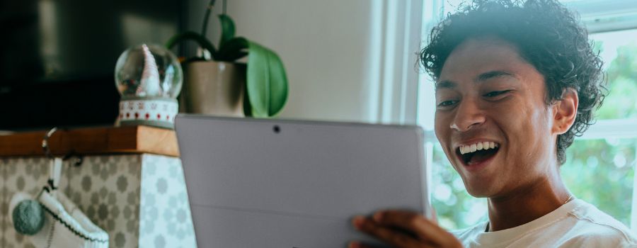 A person holding a tablet and smiling