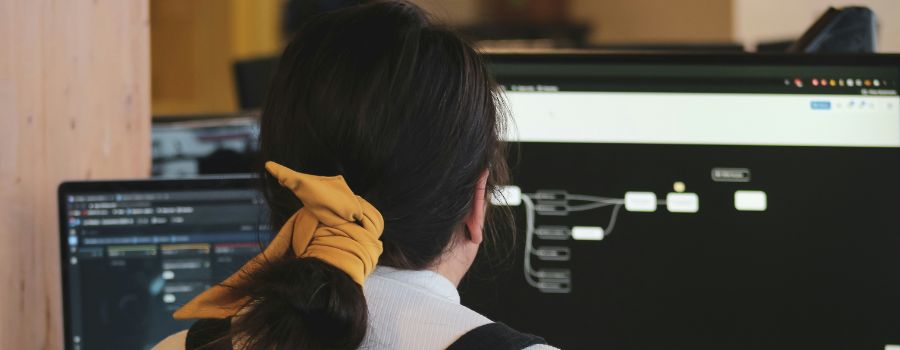 The back of someone working on a computer, coding