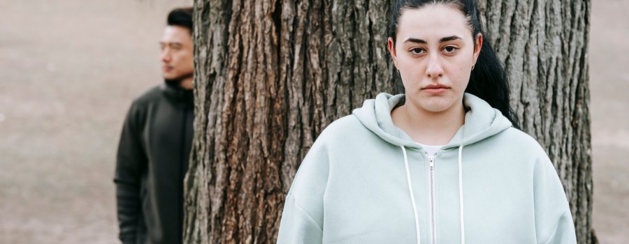 Contemplative young adults in a serene autumn park scene, reflecting emotional depth