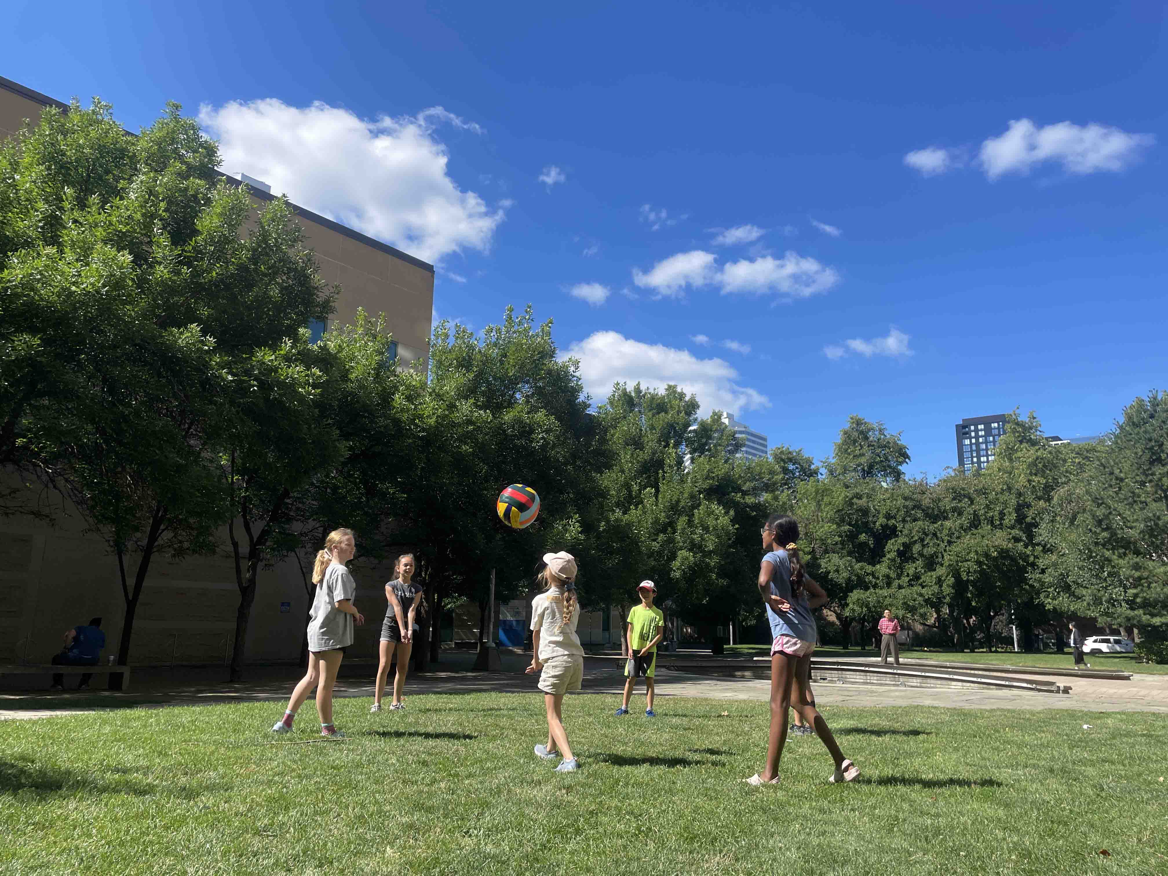Campers playing volleyball outdoors.