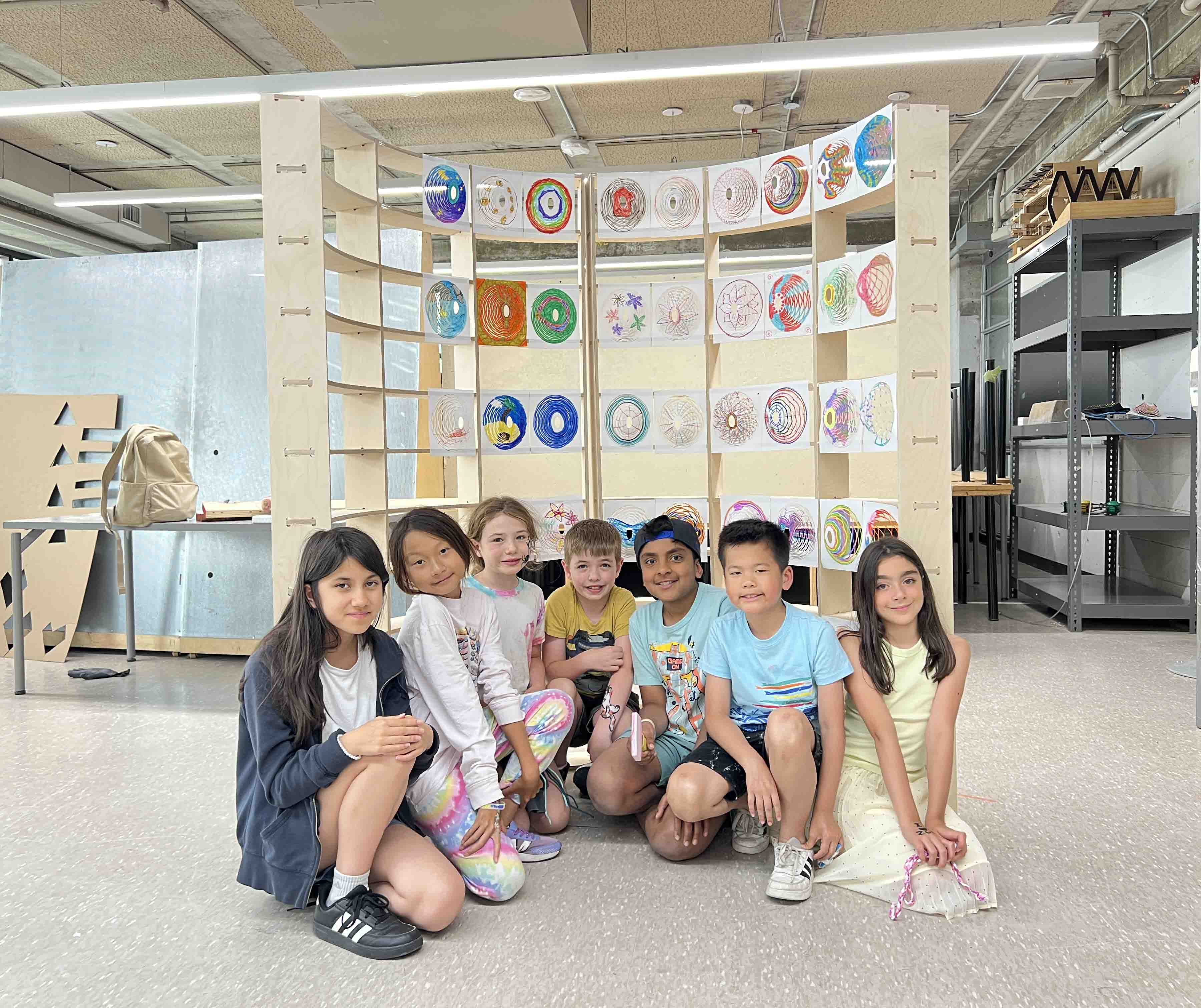 Campers sitting in front of an interactive wall.