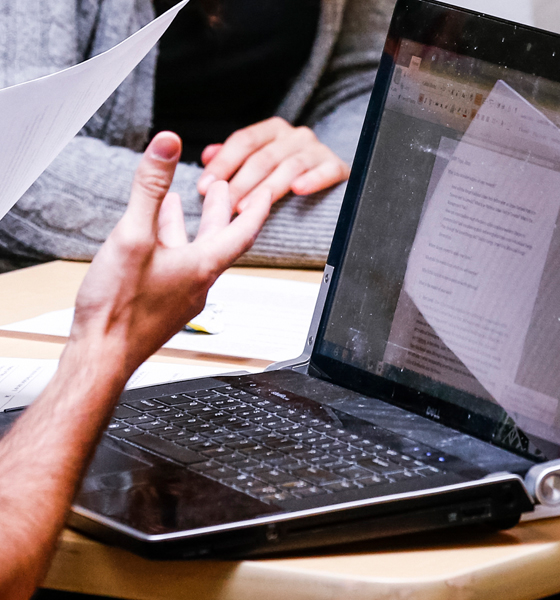 A close up of a lap top and a person's hands. 