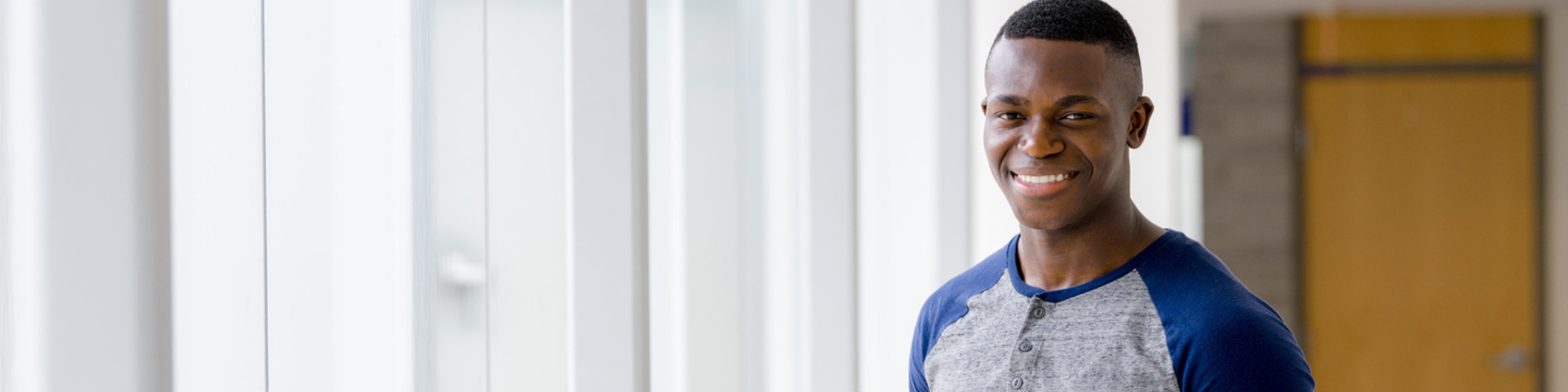 Banner of a young man smiling at the camera