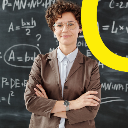 A female instructor standing in front of a blackboard.
