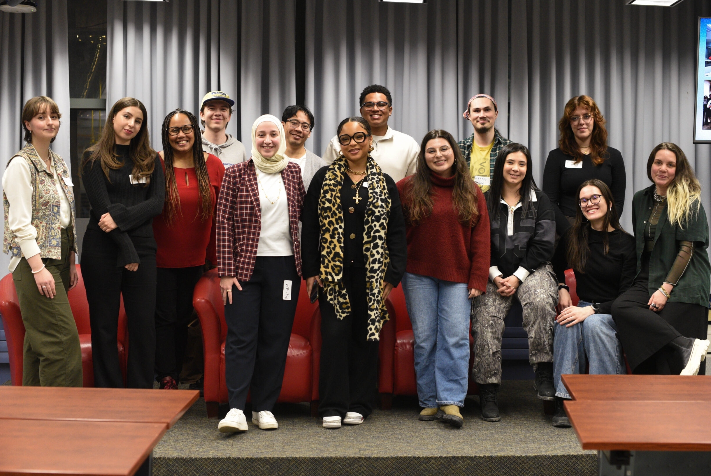 A class of journalism students smiling and and celebrating the new season of the We Met U When podcast at the launch party