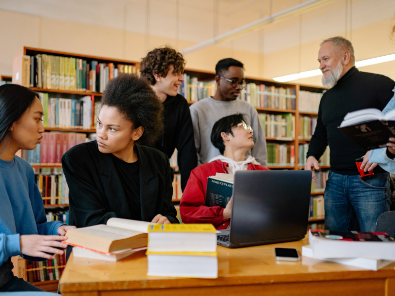 Five students and an instructor talking to each other